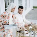 Para muzułmańska przy śniadaniu z herbatą i croissantami na świeżym powietrzu